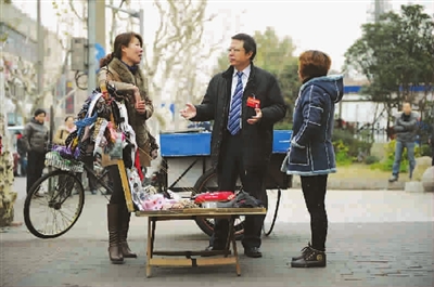 厲明代表與兩個賣圍巾襪子的女?dāng)傊鹘徽?記者 陳正寶 攝